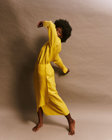 Men and women asymmetrical wrap skirt in yellow linen deadstock fabric with mother-of-pearl buttons model Odette LES DUNES.